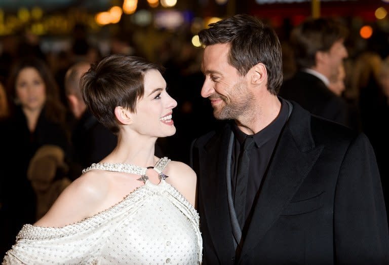 Anne Hathaway (L) and Hugh Jackman pose for photographers on the red carpet ahead of the world premiere of "Les Miserables" in central London on December 5, 2012. Steven Spielberg's political drama "Lincoln", the film version of hit stage musical "Les Miserables" and Ang Lee's "Life of Pi" lead the nominations for the BAFTAs announced in London on Wednesday