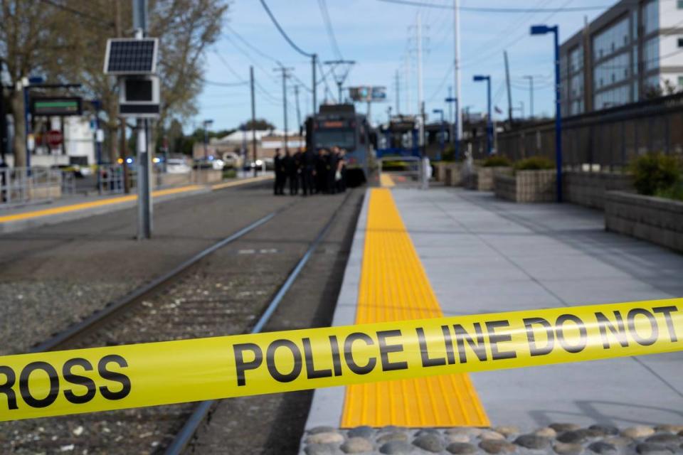 Sacramento Police investigate a shooting with one dead and two hospitalized at the 65th Street light-rail station in East Sacramento on Thursday.