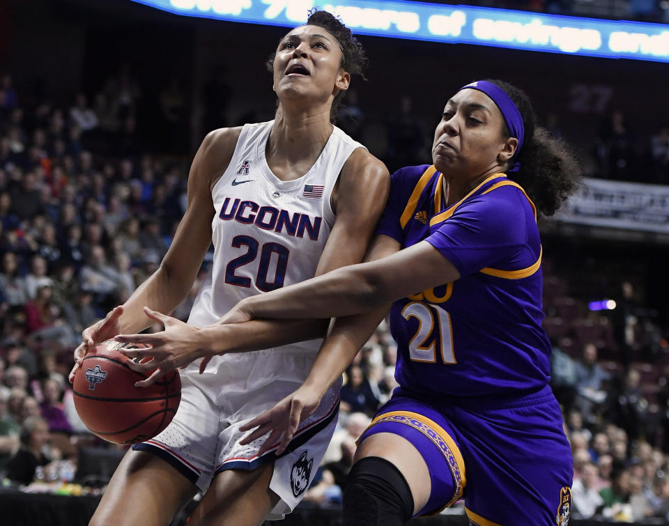 East Carolina's Salita Greene, right, fouls Connecticut's Olivia Nelson-Ododa, left, during the first half of an NCAA college basketball game in the American Athletic Conference tournament quarterfinals, Saturday, March 9, 2019, at Mohegan Sun Arena in Uncasville, Conn. (AP Photo/Jessica Hill)