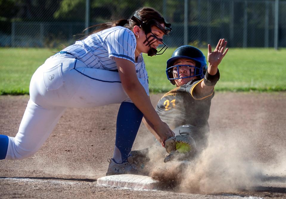 Stagg's Jorge Hernandez, right, slides safely at third on a triple as Bear Creek's Laura Mejia tries to make the tag during a varsity softball game at Bear Creek High in Stockton on May, 1, 2024.