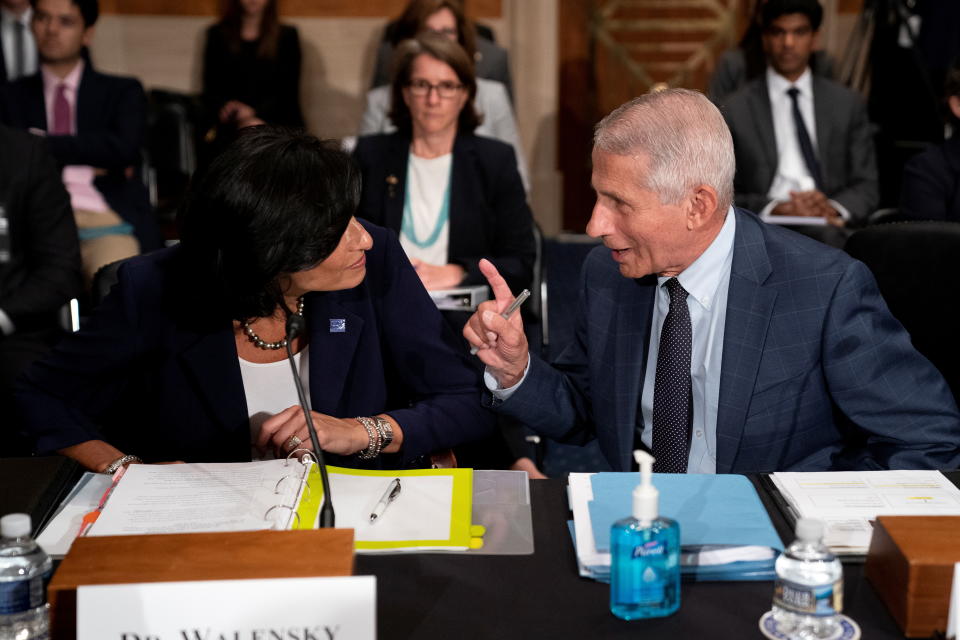 Dr. Anthony Fauci, director of the National Institute of Allergy and Infectious Diseases, speaks to Rochelle Walensky, Director of the Centers for Disease Control and Prevention, prior to  a Senate Health, Education, Labor, and Pensions Committee hearing on Capitol hill in Washington, D.C., U.S., July 20, 2021. Stefani Reynolds/Pool via REUTERS