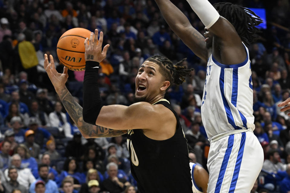 FILE - Then-Vanderbilt forward Myles Stute (10) goes to the basket past Kentucky forward Chris Livingston during the first half of an NCAA college basketball game in the quarterfinals of the Southeastern Conference Tournament, Friday, March 10, 2023, in Nashville, Tenn. South Carolina coach Lamont Paris brought in several transfers this season, including 6-foot-6 guard Myles Stute who started 59 games in three seasons at Vanderbilt. (AP Photo/John Amis, File)