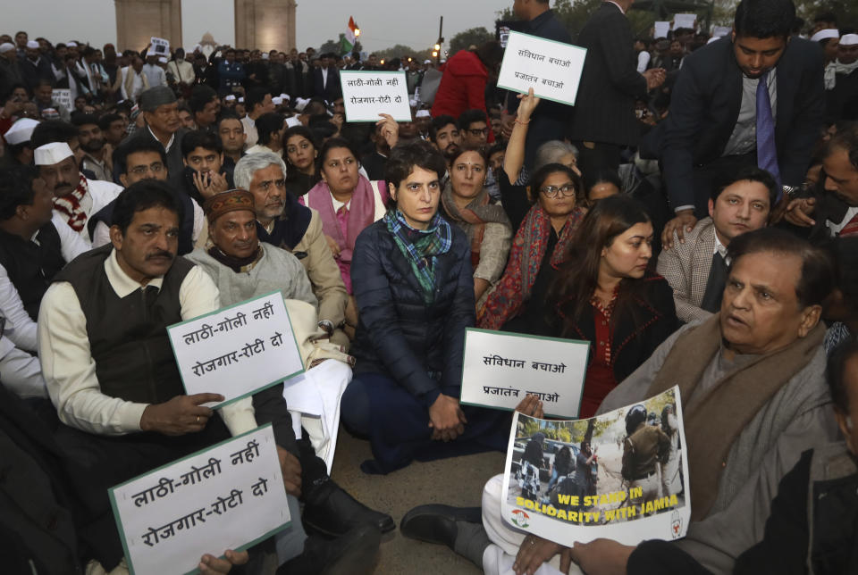 Congress party leader Priyanka Gandhi, center, joins other leaders during a sit in protest against a new citizenship law near the India Gate monument in New Delhi, India, Monday, Dec.16, 2019. The new law gives citizenship to non-Muslims who entered India illegally to flee religious persecution in several neighboring countries. (AP Photo/Manish Swarup)