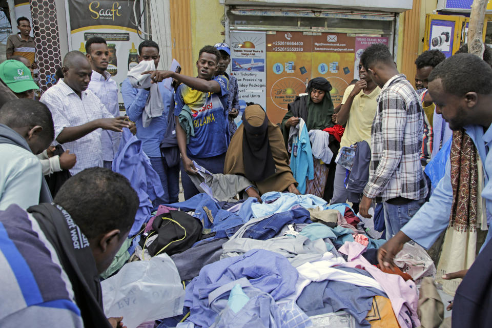 People shop at a street market as preparations are made for the Muslim holiday of Eid al-Fitr, next Friday, which marks the end of the holy fasting month of Ramadan, in Mogadishu, Somalia, Wednesday, April 19, 2023. (AP Photo/Farah Abdi Warsameh)