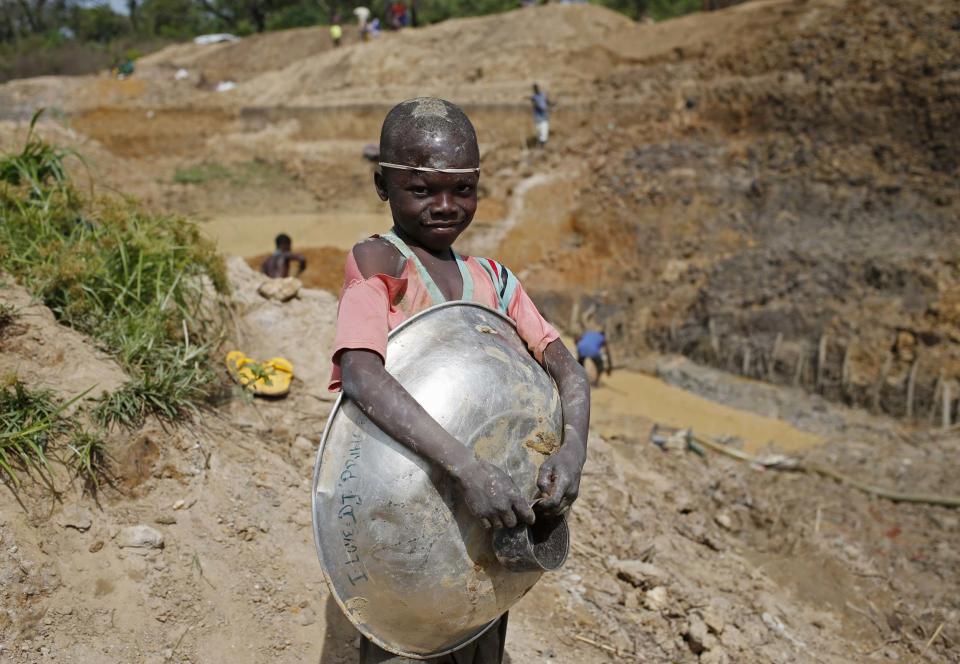 A boy takes a break as he searches for gold and diamonds near the town of Gaga