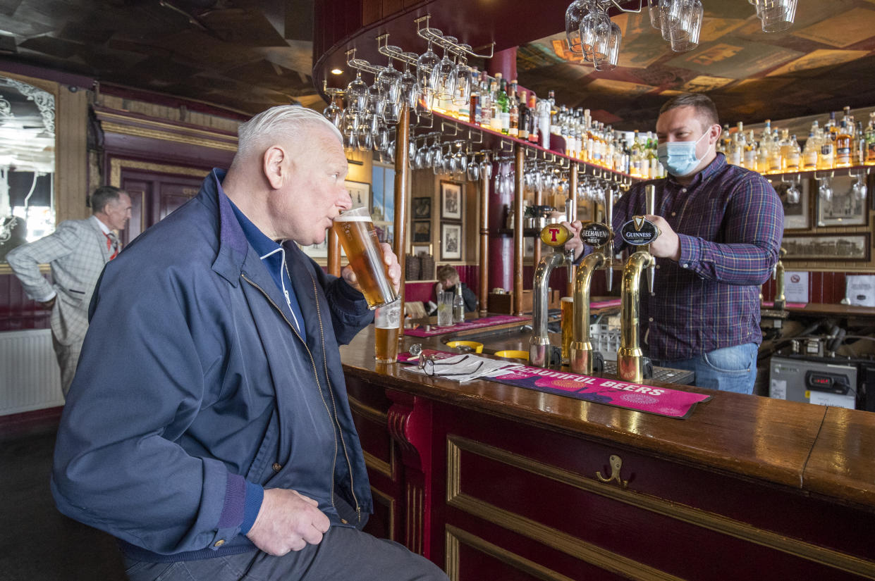 Customers in the Waverley, Edinburgh, enjoy a drink inside the bar. Alcohol can now be served inside pubs and restaurants, which are allowed to stay open until 22.30, as Scotland moves to Level 2 restrictions to ease out of lockdown.