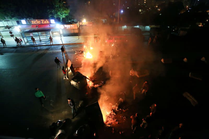 FILE PHOTO: Protestors block a road by burning barricades against the designation of Hassan Diab, Lebanon's newly named prime minister, in Beirut