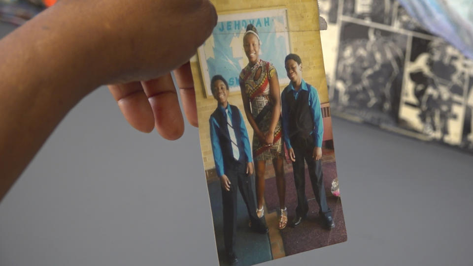 Nadine Young holds a childhood photograph of her grandchildren, including Ta'Kiya Young, center, at the law offices of the family attorney in Columbus, Ohio, on Wednesday, Sept. 6, 2023. Ta'Kiya Young was shot and killed on Aug. 24 by Blendon Township police outside an Ohio supermarket. The 21-year-old was pregnant and due to give birth in November, according to her family. (AP Photo/Patrick Orsagos)