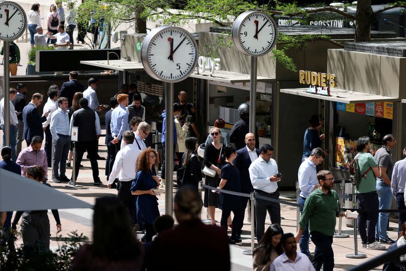 FILE PHOTO: People queue for food in the financial district of Canary Wharf