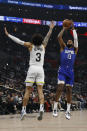 Los Angeles Clippers forward Paul George (13) shoots a 3-pointer against Utah Jazz guard Keyonte George (3) during the first half of an NBA basketball game Friday, April 5, 2024, in Los Angeles. (AP Photo/Etienne Laurent)