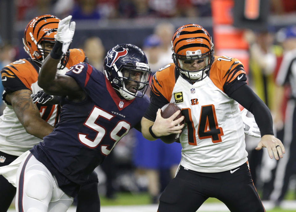 FILE - Cincinnati Bengals quarterback Andy Dalton (14) is sacked by Houston Texans outside linebacker Whitney Mercilus (59) during the second half of an NFL football game, Saturday, Dec. 24, 2016, in Houston. Outside linebacker Whitney Mercilus says he’s retiring, ending a 10-year career in which he recorded 58 sacks. Mercilus announced his decision Wednesday, April 6, 2022, via Instagram. (AP Photo/Sam Craft, File)
