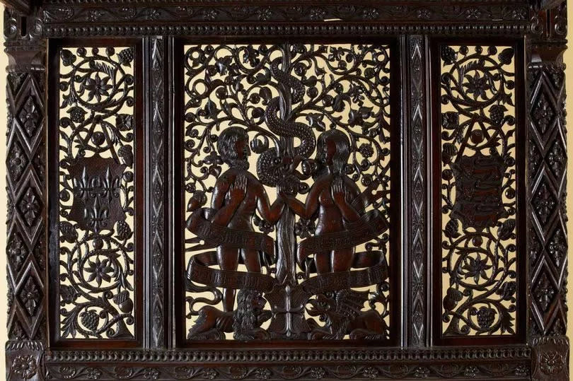 The bed's decorative headboard of the Paradise State Bed depicts Adam and Eve in likeness of the King Henry VII and his Queen