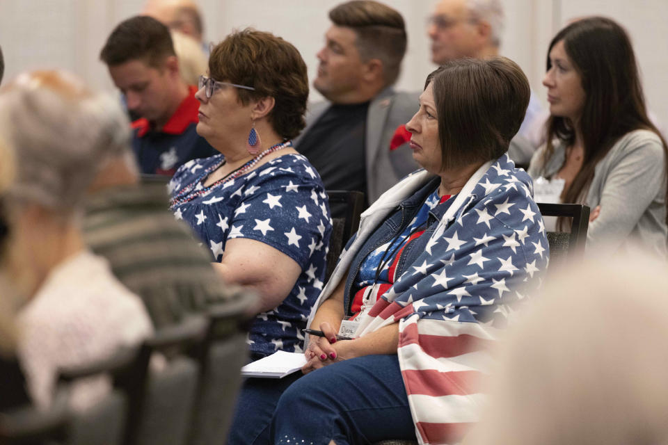 Sisters Lori Ediger, left, of Aurora, Neb., and Diana Johnson of Henderson, Neb., listen to presentations during the Nebraska Election Integrity Forum on Saturday, Aug. 27, 2022, in Omaha, Neb. (AP Photo/Rebecca S. Gratz)