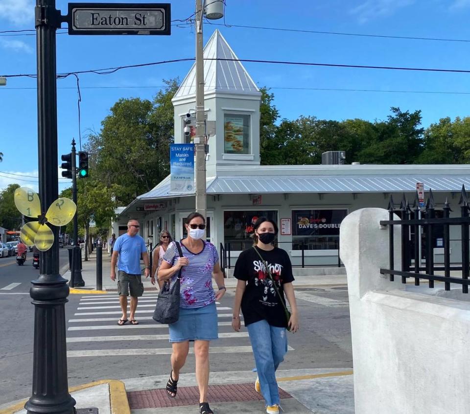 Passersby on Duval Street in Key West wear masks on Nov. 3, 2020. The city of Key West is considering a curfew to help stop the spread of the novel coronavirus.