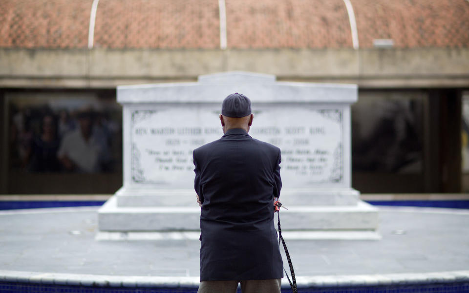 <p>Jeremiah Bridgewater visits the gravesite of the Rev. Martin Luther King Jr., on the 50th anniversary of his assassination in Atlanta, Wednesday, April 4, 2018. “It’s heart wrenching. Fifty years ago most of us try to remember where we were and because of his sacrifices we can enjoy some of the pleasures we once weren’t able to,” said Bridgewater. “We’re still not where we ought to be but at least we’re further down the road.” (Photo: David Goldman/AP) </p>