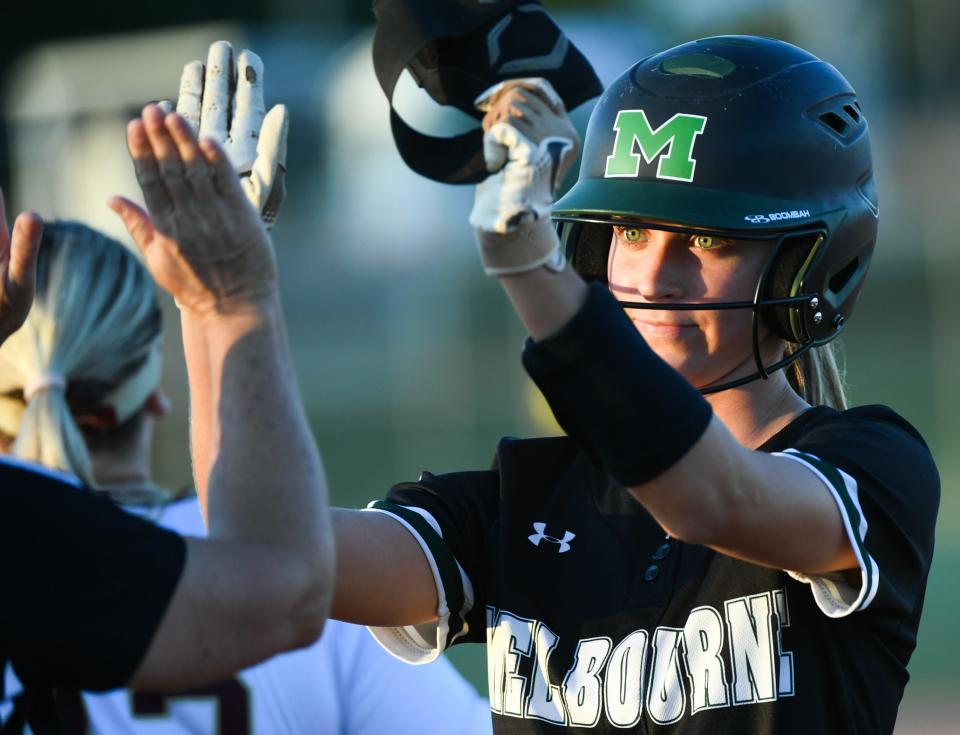 Hailey Turner of Melbourne gets high fived after her base hit during the Cape Coast Conference softball title game Wednesday, April 17, 2024. Craig Bailey/FLORIDA TODAY via USA TODAY NETWORK