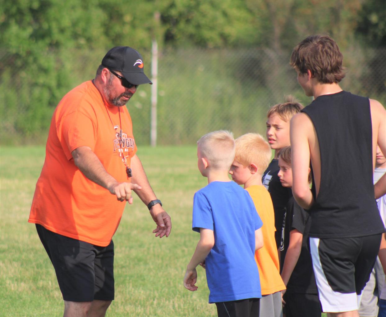 Cheboygan assistant varsity football coach Adam Bury instructs campers during Monday's Cheboygan youth football camp session at Western Avenue Field.