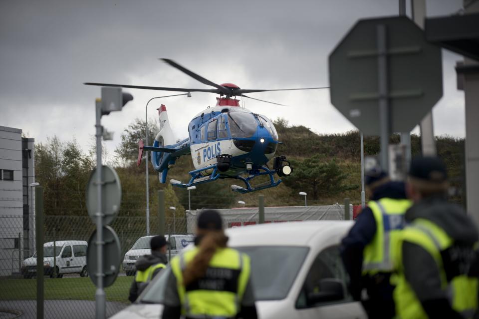 A police helicopter on the scene after several Greenpeace activists conducted what the organization called a ‘stress test’ of the security at the nuclear power plant in Ringhals on the Swedish west coast Tuesday Oct. 9, 2012. Swedish nuclear power officials say that police have arrested dozens of environmental activists who climbed fences to breach the outer perimeter of two atomic plants. (AP Photo/Bjorn Larsson Rosvall / SCANPIX ) SWEDEN OUT