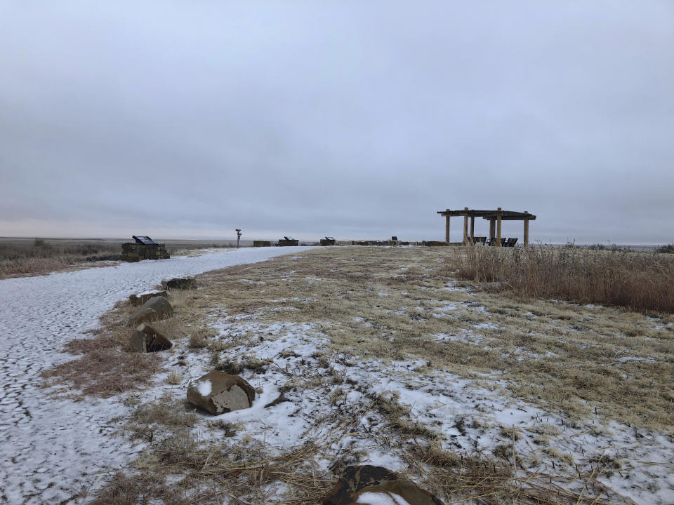 In this Dec. 27, 2019, photo, "Monument Hill" is shown at the Sand Creek Massacre National Historic Site in Eads, Colo. This quiet piece of land tucked away in rural southeastern Colorado seeks to honor the 230 peaceful Cheyenne and Arapaho tribe members who were slaughtered by the U.S. Army in 1864. It was one of worst mass murders in U.S. history. (AP Photo/Russell Contreras)