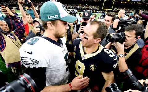 Philadelphia Eagles quarterback Nick Foles (9) and New Orleans Saints quarterback Drew Brees (9) meet after a NFC Divisional playoff football game at Mercedes-Benz Superdome - Credit: USA TODAY