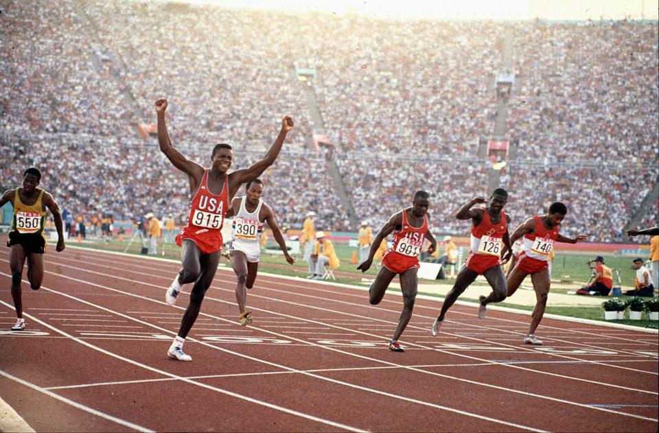 Carl Lewis crosses the finish line with arms in the air, winning the Gold for the men's 100m in the 1984 Olympics in Los Angeles, Ca. on Aug. 4, 1984. He was the first person since Jesse Owens in the 1936 Berlin Olympic Games to win four gold medals at a single Olympics.