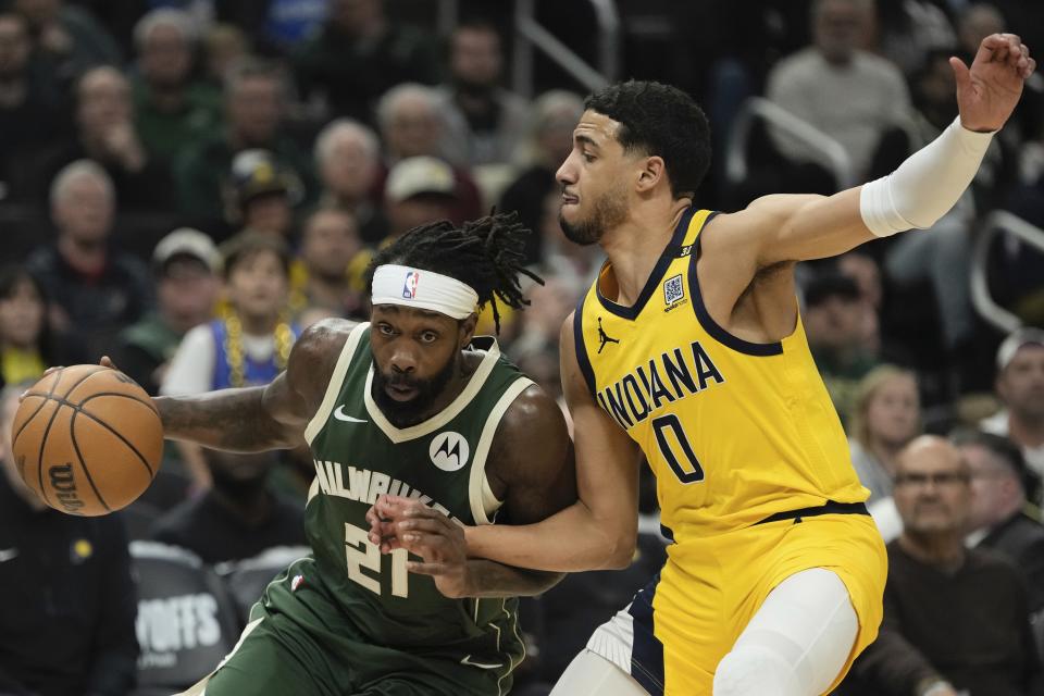Milwaukee Bucks' Patrick Beverley gets past Indiana Pacers' Tyrese Haliburton during the first half of Game 1 of the NBA playoff basketball game Sunday, April 21, 2024, in Milwaukee. (AP Photo/Morry Gash)