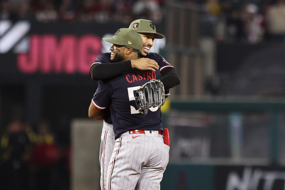 Minnesota Twins shortstop Carlos Correa (4) and second baseman Willi Castro (50) embrace after defeating the Los Angeles Angels 6-2 during a baseball game in Anaheim, Calif., Saturday, May 20, 2023. (AP Photo/Jessie Alcheh)