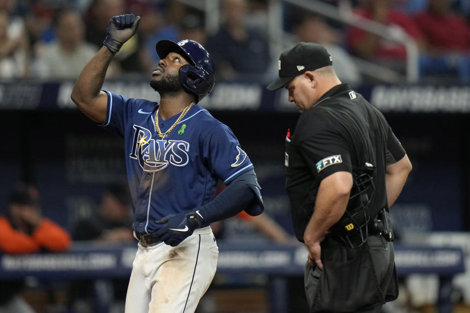 Tampa Bay Rays' Randy Arozarena celebrates after his home run off Detroit Tigers relief pitcher Will Vest during the eighth inning of a baseball game Tuesday, May 17, 2022, in St. Petersburg, Fla. Looking on is home plate umpire Jeremy Riggs. (AP Photo/Chris O'Meara)