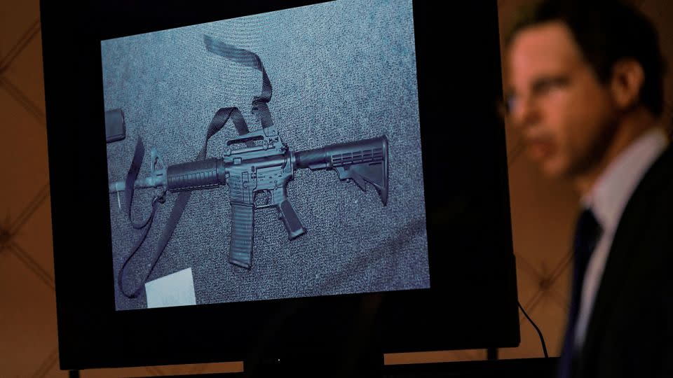 An image of the weapon used during the Sandy Hook school shooting is displayed while attorney Josh Koskoff speaks during a news conference in Trumbull, Connecticut, on February 15, 2022. - Seth Wenig/AP