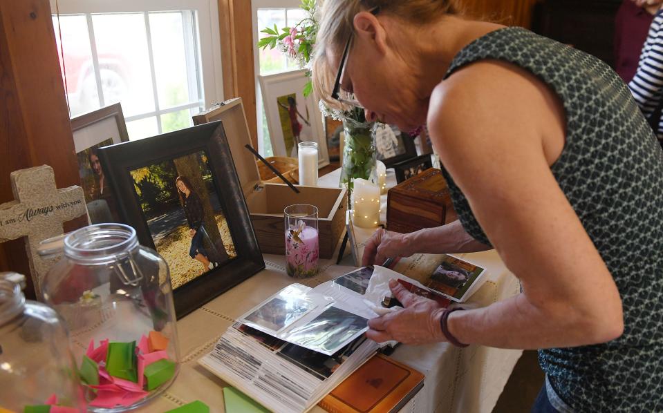 Tammy Spangler, Jessica Haitt's aunt, looks at the display of Jessica's memories during her celebration of life event at Slater City Park Monday, May 16, 2022, in Slater, Iowa.