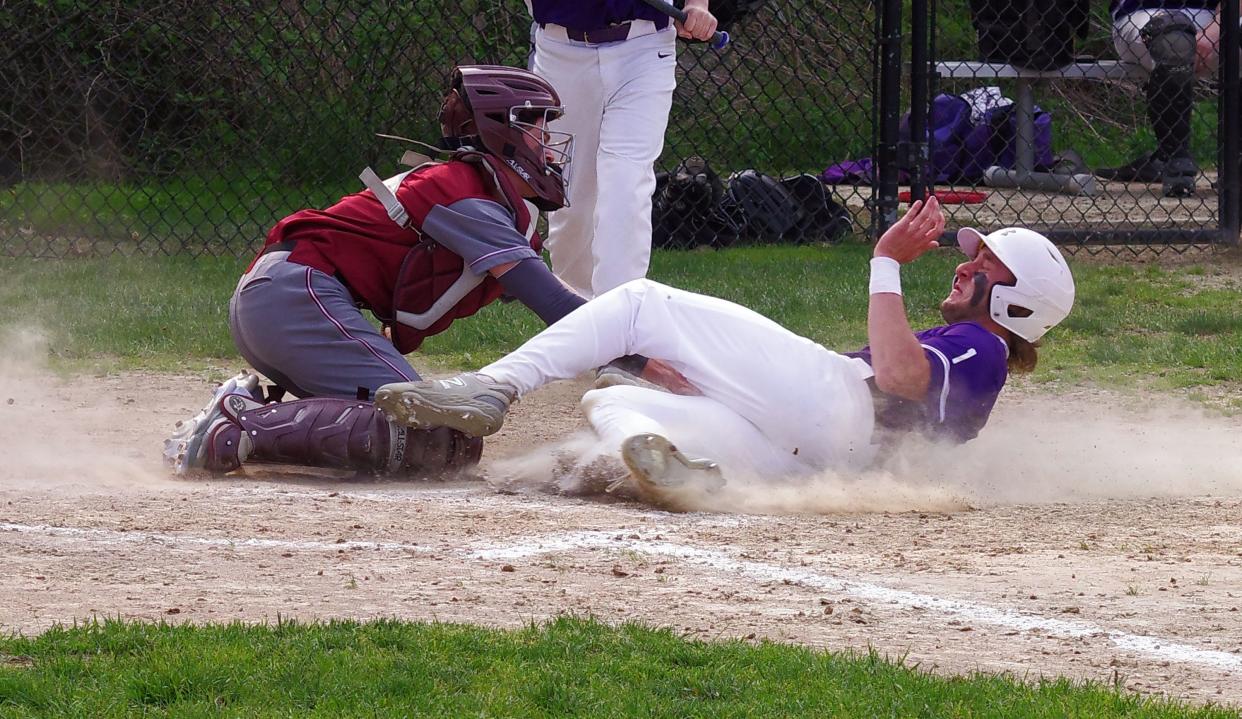 After scoring earlier in the fourth inning, Bourne's Aidan Elmore of Bourne looks to add another run by trying to steal home. But West Bridgewater catcher Ryan Nunes was ready and made the out, leaving the game deadlocked at 2-2 on Monday, May 8, 2023.