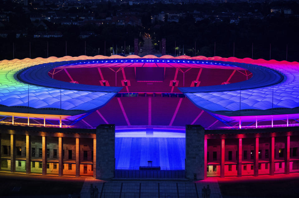 The Olympic Stadium in Berlin is lit up in rainbow colors during the Euro 2020 soccer match between Germany and Hungary held in Munich, Wednesday, June 23, 2021. The UEFA didn't allow Munich to illuminate the stadium for this evening's Euro 2020 match in rainbow colors in a show of support for LGBT people. The decision by European soccer's governing body was widely criticized in Germany, which plays Hungary in the final group match in Munich. (Christophe Gateau/dpa via AP)