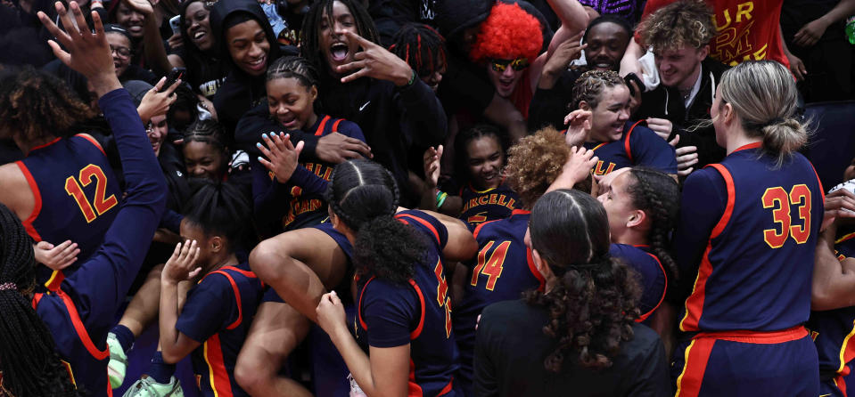 Purcell Marian players and fans celebrate their third championship in a row after beating Laurel in the OHSAA DII state final Saturday, March 16, 2024.