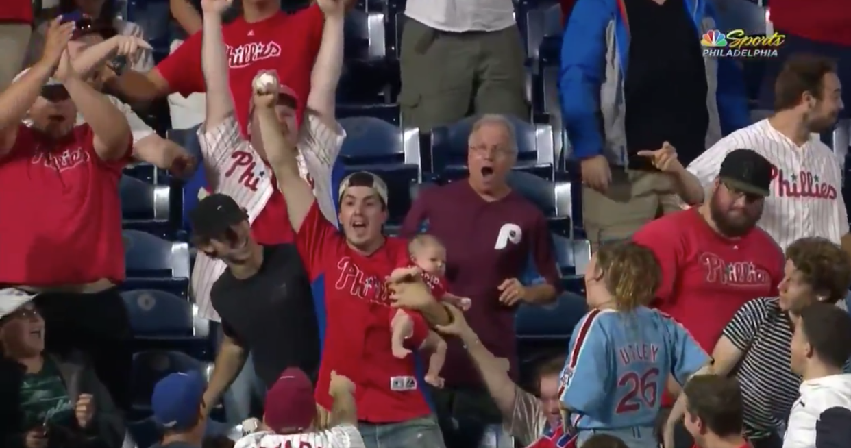 A Philadelphia Phillies fan expertly snagged a home run ball in mid air on Monday night while holding his baby in his other arm. (Twitter/NBCSPhilly)