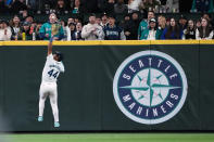 Seattle Mariners center fielder Julio Rodríguez jumps up to make the catch on a line drive by Cincinnati Reds' Spencer Steer during the seventh inning of a baseball game Tuesday, April 16, 2024, in Seattle. (AP Photo/Lindsey Wasson)