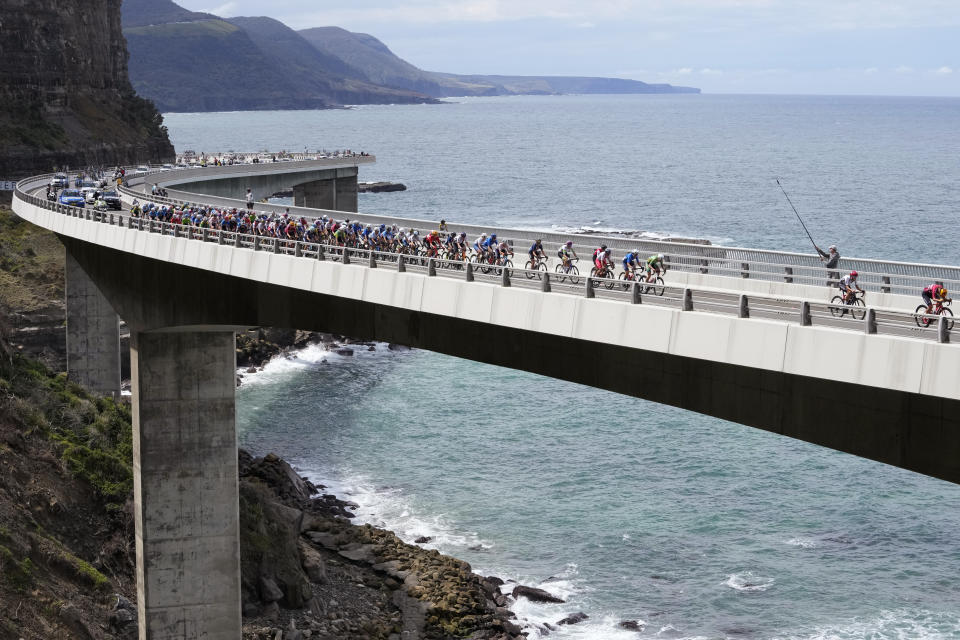 Riders cross the Sea Bridge during the elite women's road race at the world road cycling championships in Wollongong, Saturday, Sept. 24, 2022. (AP Photo/Rick Rycroft)