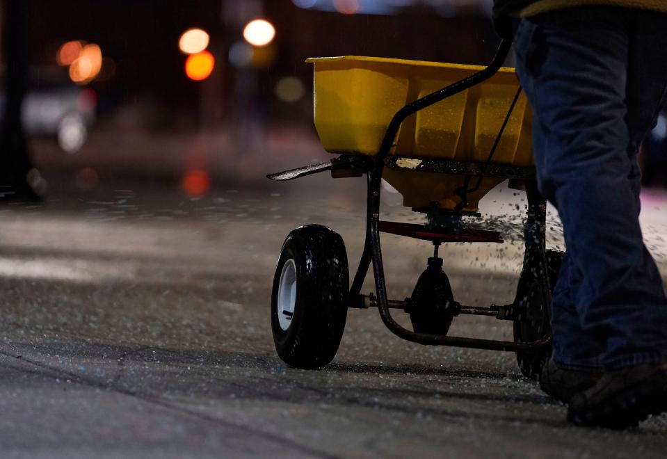 Salt is spread on the sidewalks in downtown Indianapolis Wednesday, Feb. 2, 2022, in Indianapolis.