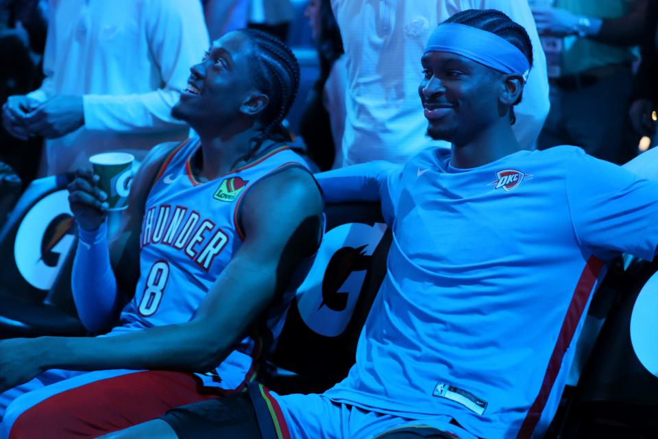 Oklahoma City Thunder guard Shai Gilgeous-Alexander (2) and forward Jalen Williams (8) sit during introductions before an NBA basketball game between the Oklahoma City Thunder and the Sacramento Kings at Paycom Center in Oklahoma City, Tuesday, April 9, 2024. Oklahoma City won 112-105.