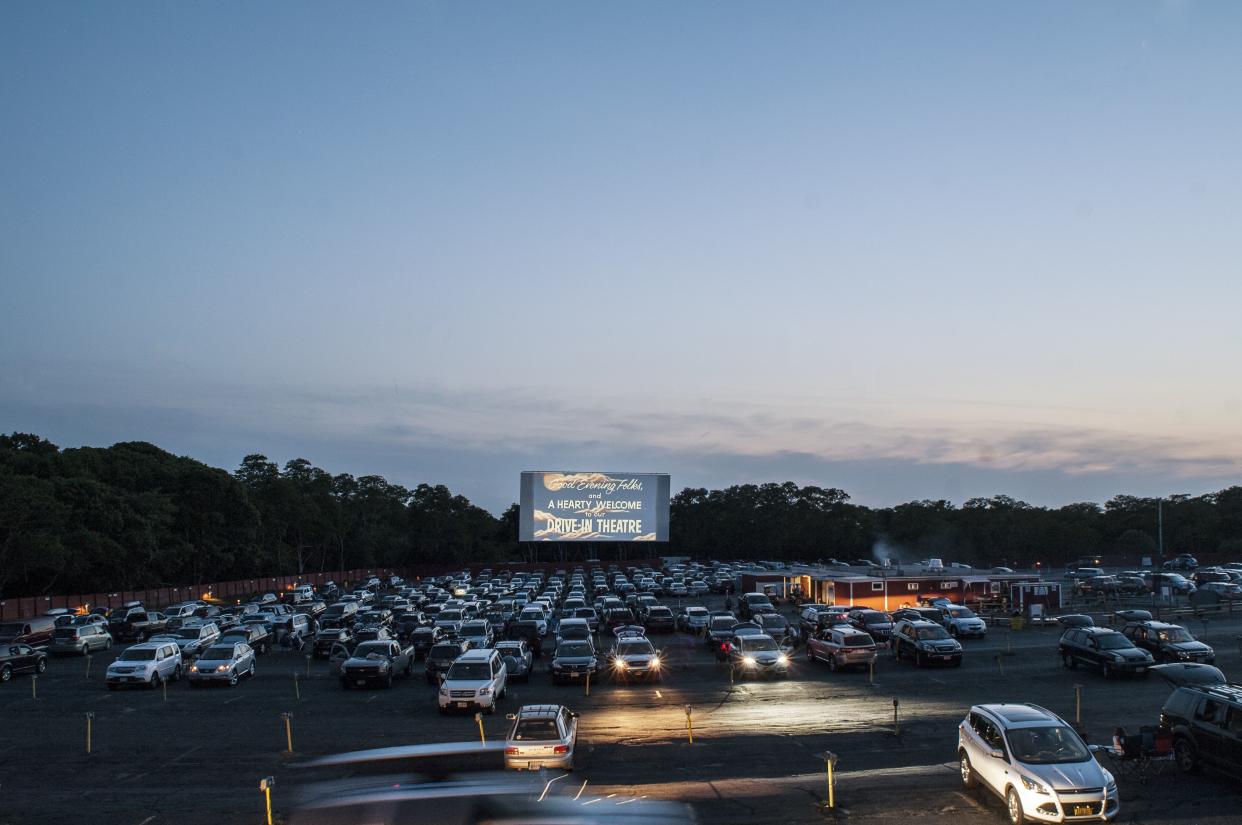 Cars parked at Wellfleet Drive-In Theatre waiting for film to begin at dusk.