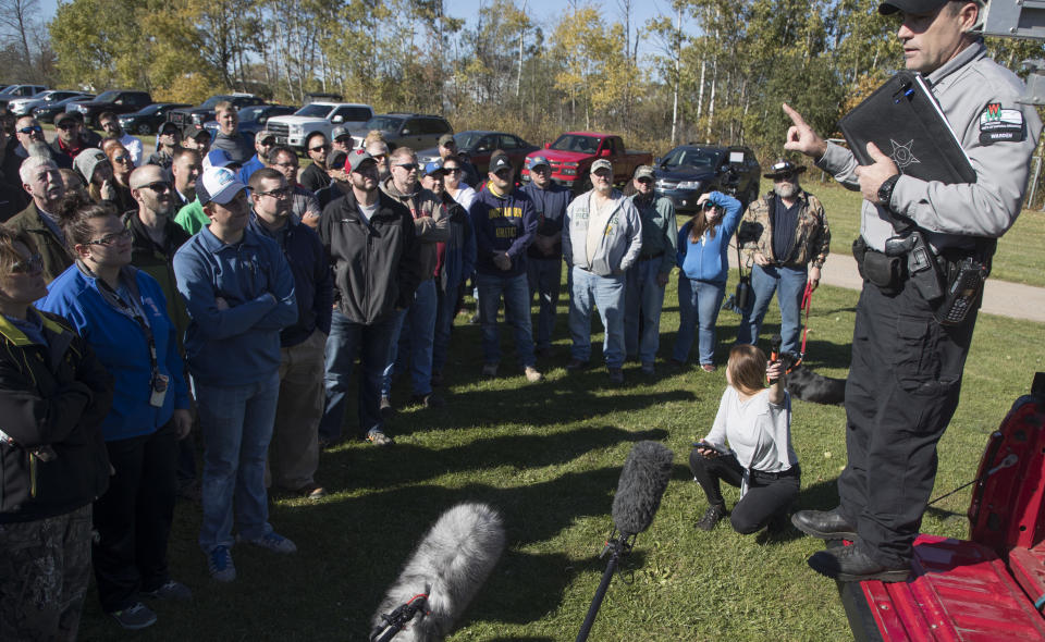 Wisconsin DNR warden Supervisor Russell T Fell selected 100 volunteers to searched the ditches along highway 8, Thursday, Oct. 18, 2018, in Barron, Wis., near the home where 13-year-old Jayme Closs lived with her parents James, and Denise. (Jerry Holt /Star Tribune via AP)