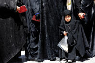 <p>A veiled little Iranian girl stands in a line with her mother among women queing to vote in the Iranian presidential elections at the polling station in the Abdol Azim shrine, in the city of Shahre-Ray, 12 km south of Tehran, Iran, May 19, 2017. Out of the candidates, the race is tightest between frontrunners Iranian current president Hassan Rouhani and conservative presidential candidate Ebrahim Raisi. (Photo: Abedin Taherkenareh/EPA) </p>