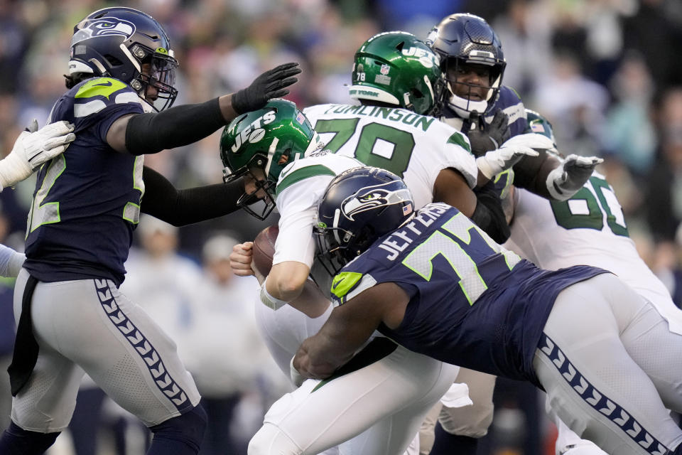 New York Jets quarterback Mike White (5) is sacked by Seattle Seahawks defensive tackle Quinton Jefferson (77) during the second half of an NFL football game, Sunday, Jan. 1, 2023, in Seattle. (AP Photo/Godofredo A. Vásquez)