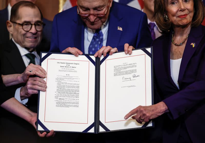 U.S. House Speaker Nancy Pelosi signs "The Respect for Marriage Act" on Capitol Hill