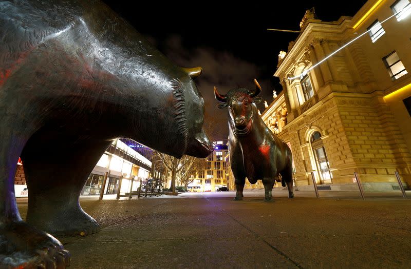 FILE PHOTO: Bull and bear symbols for successful and bad trading are seen in front of the German stock exchange (Deutsche Boerse) in Frankfurt