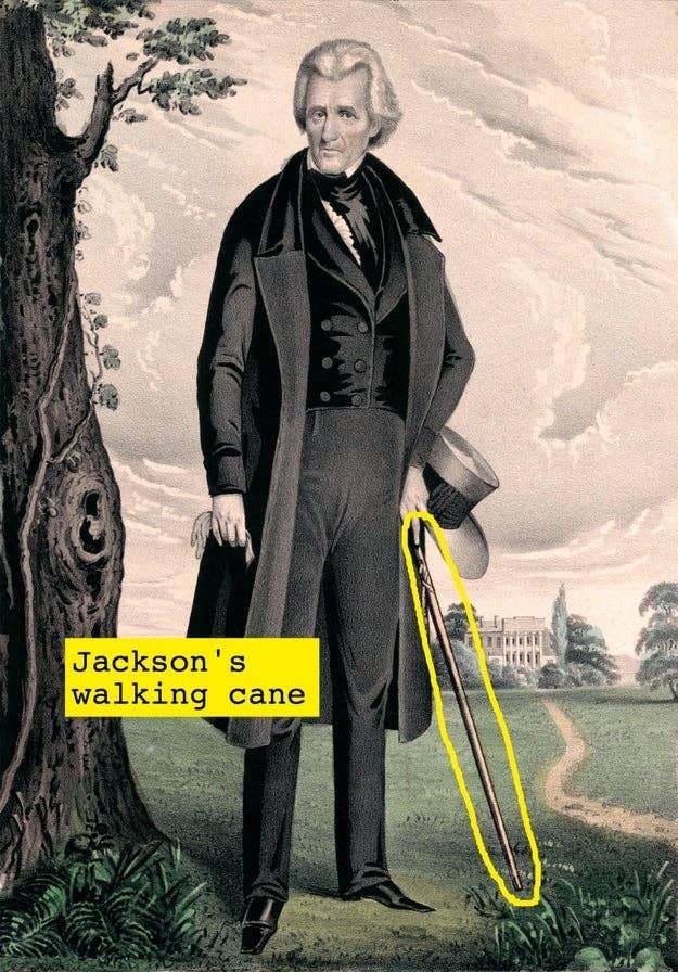 Andrew Jackson holding a top hat and a walking cane, standing in front of a large estate and trees with "Jackson's walking cane" highlighted