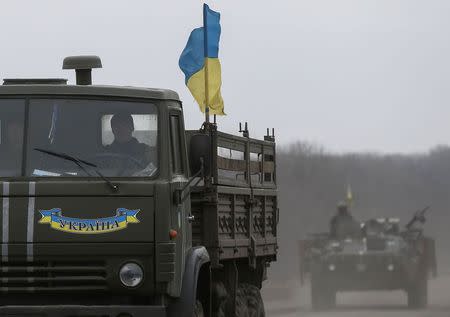 Members of the Ukrainian armed forces ride on military vehicles near Artemivsk, eastern Ukraine, March 3, 2015. REUTERS/Gleb Garanich