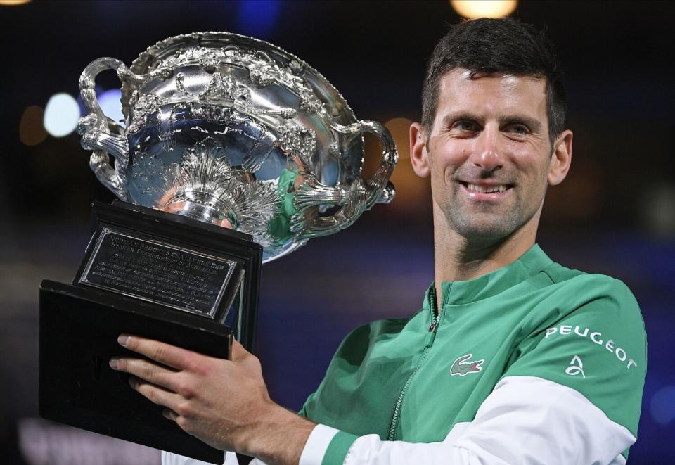 Novak Djokovic holds the Norman Brookes Challenge Cup after defeating Russia's Daniil Medvedev in 2021.
