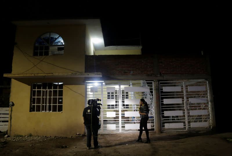 Members of the media work outside a drug rehabilitation facility where assailants killed several people according to Guanajuato state police, in Irapuato, Mexico