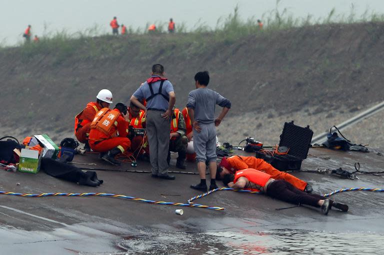 Chinese rescue workers use listening devices to detect survivors inside the capsized Dongfangzhixing or "Eastern Star" vessel which sank in the Yangtze river in Jianli, central China's Hubei province on June 2, 2015