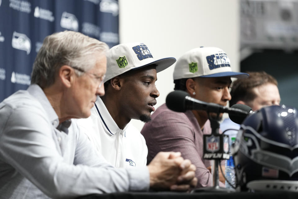 Seattle Seahawks first-round NFL football draft pick Devon Witherspoon, second from left, speaks during a news conference with head coach Pete Carroll, left, and fellow first-round pick Jaxon Smith-Njigba, third from left, Friday, April 28, 2023, at the team's headquarters in Renton, Wash. (AP Photo/Lindsey Wasson)